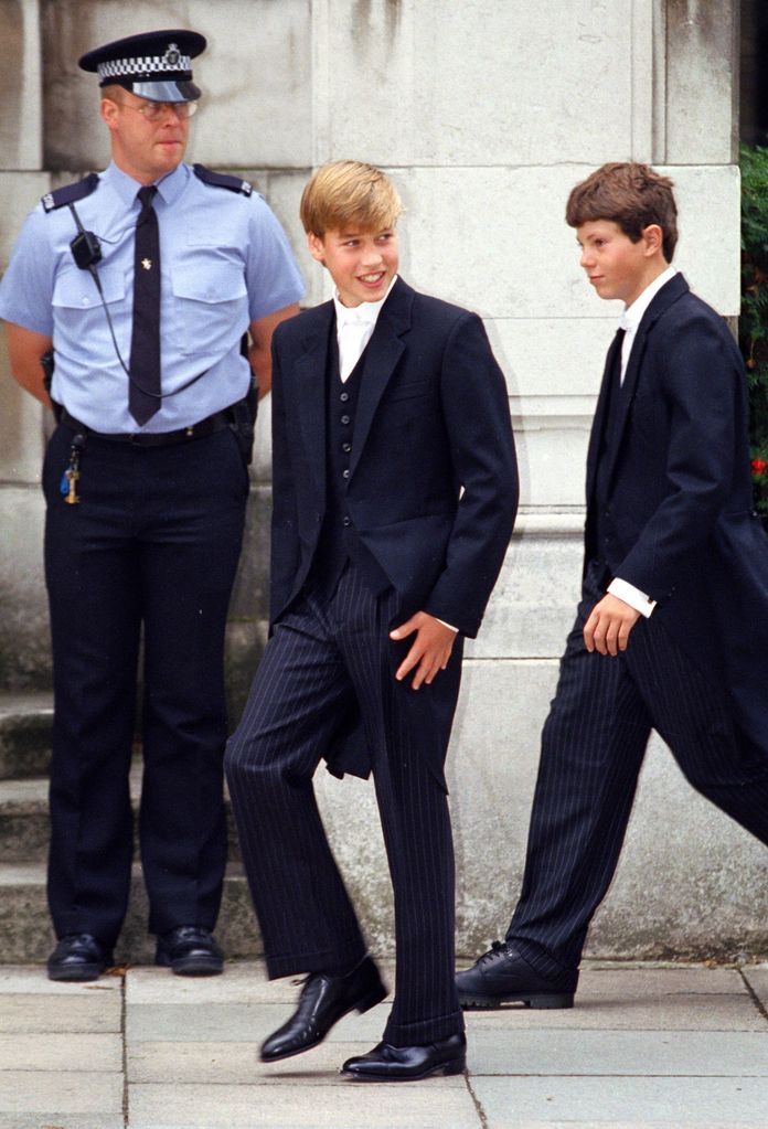 Prince William and a teenager walking past a security guard