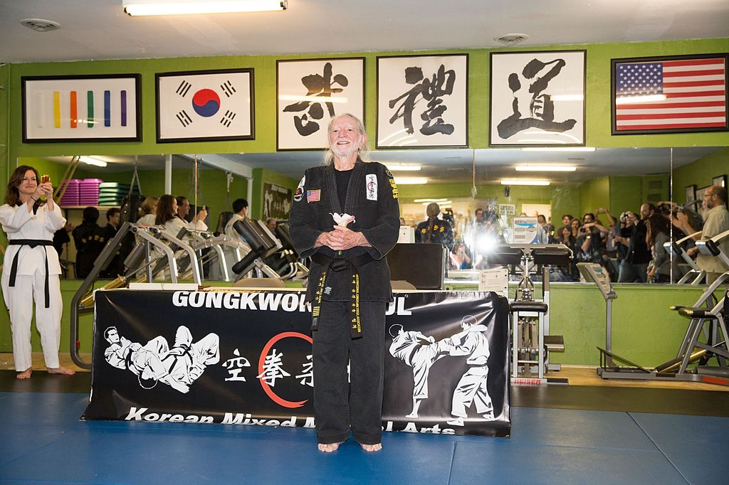 Musician Willie Nelson is presented with his 5th Degree Black Belt in the art of Gong Kwon Yu Sul by Grand Master Sam Um at his studio Master Martial Arts on April 28, 2014 in Austin, Texas
