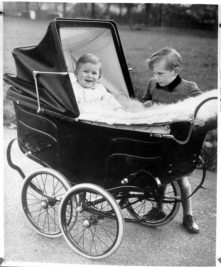 A baby King Charles in a pram with Prince Richard looking over him