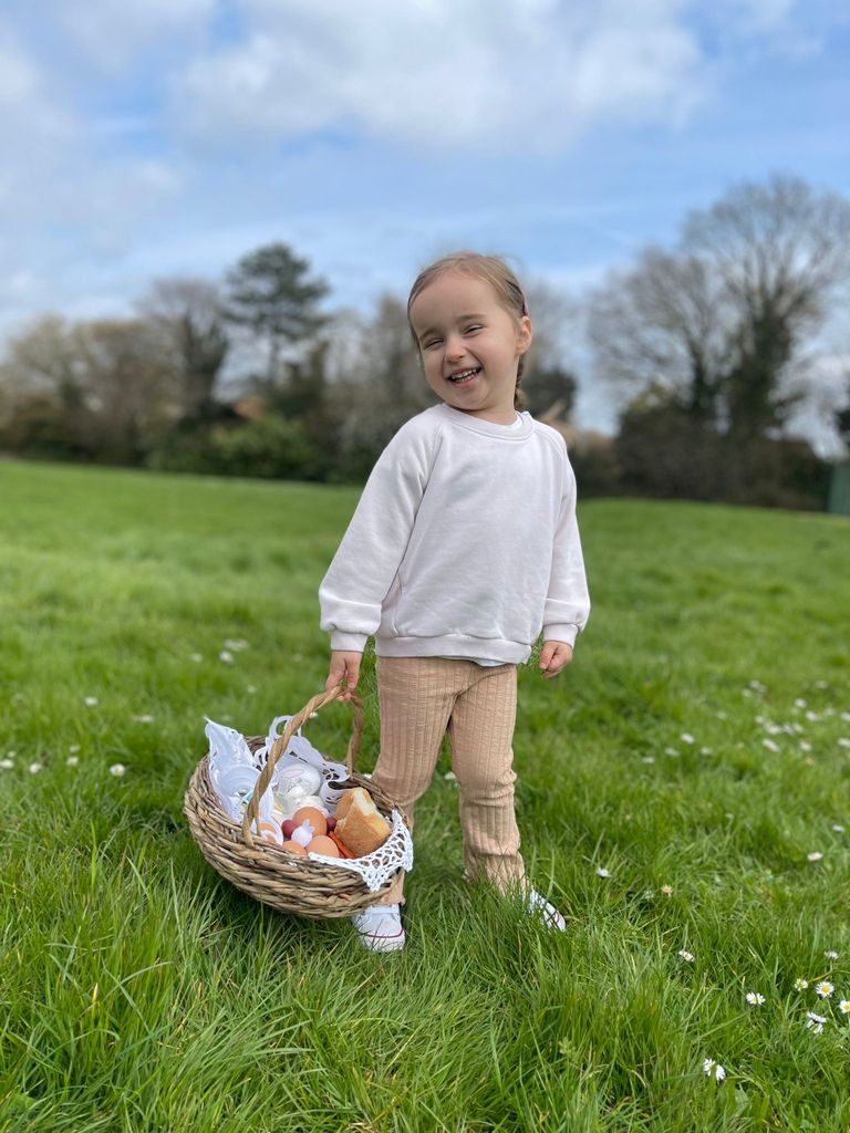Ella Jordan smiles with an Easter basket