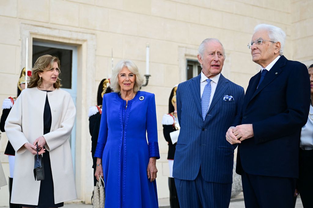 four people standing in courtyard in rome 