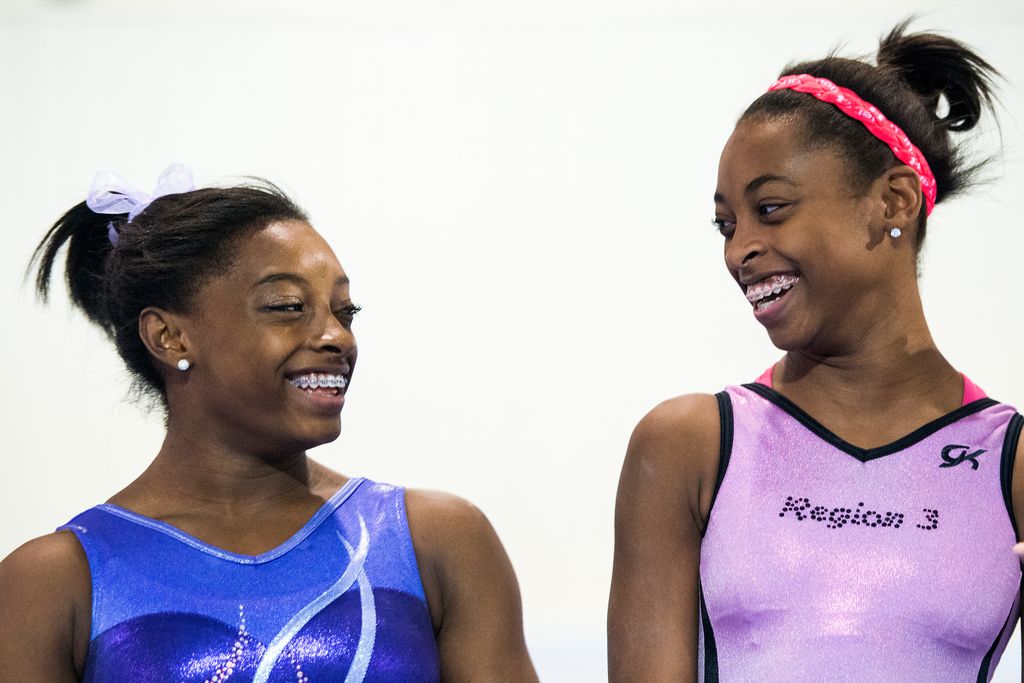 Simone Biles, left, laughs with her sister Adria while they train at Bannon's Gymnastix on Thursday, Aug. 22, 2013, in Houston.