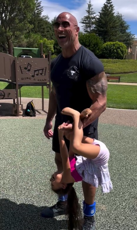 Dwayne Johnson lifting his daughter