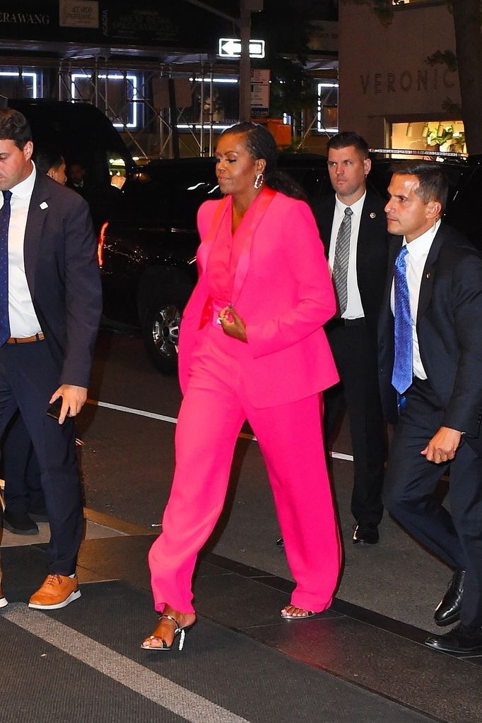 Michelle Obama wears a hot pink suit as she arrives at the George Clooney's Albie Awards after party at The Mark Hotel in New York City