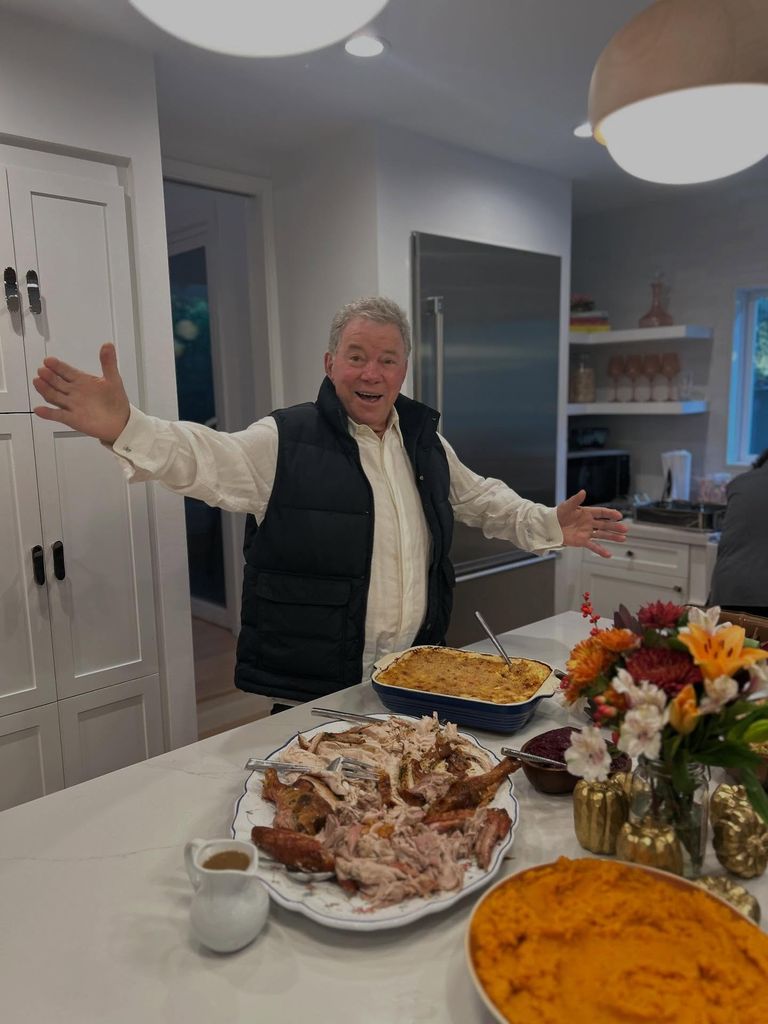 photo of william shatner standing in kitchen surrounded by thanksgiving food