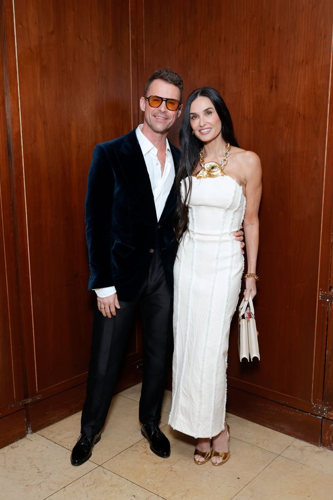 Brad Goreski and Demi Moore in white dress pose 