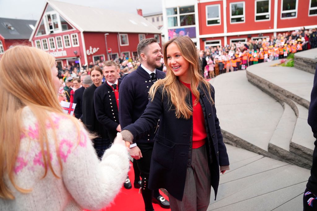 Denmark's Princess Josephine greets wellwishers as she attends an official reception with Queen Mary and King Frederik X at the city's steps in Vagsbot in Torshavn