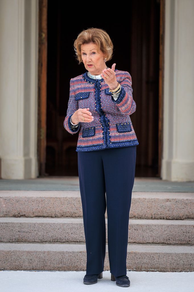 Queen Sonja in a multicoloured jumper and blue trousers