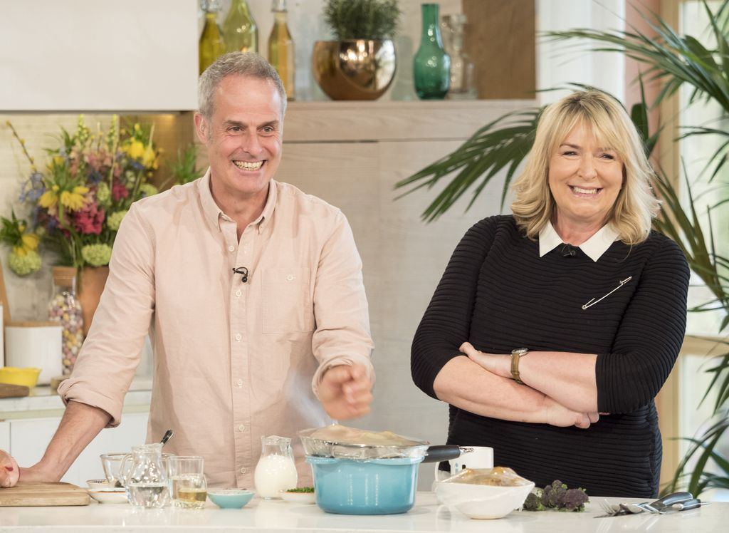 Phil Vickery and Fern Britton smiling as they stand together on This Morning in 2017
