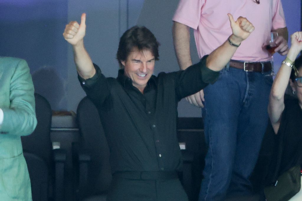 Tom Cruise celebrates the goal medal for the USA 4x100m freestyle relay during day one of the swimming event at Paris La Defense Arena on July 27, 2024 in Nanterre near Paris, France.