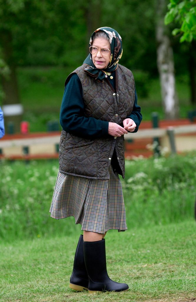 Queen Elizabeth II Dressed Casually In A Wool Skirt, Body Warmer And Wellington Boots, As She Walks Through The Grounds Of Windsor Great Park 