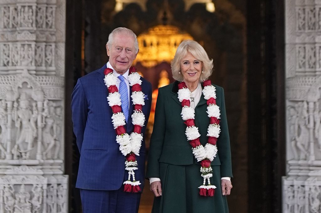 : King Charles III and Queen Camilla pose for a photo, as they arrive for a visit to BAPS Shri Swaminarayan Mandir (known as the 'Neasden Temple') on October 29, 2025 in Neasden, London