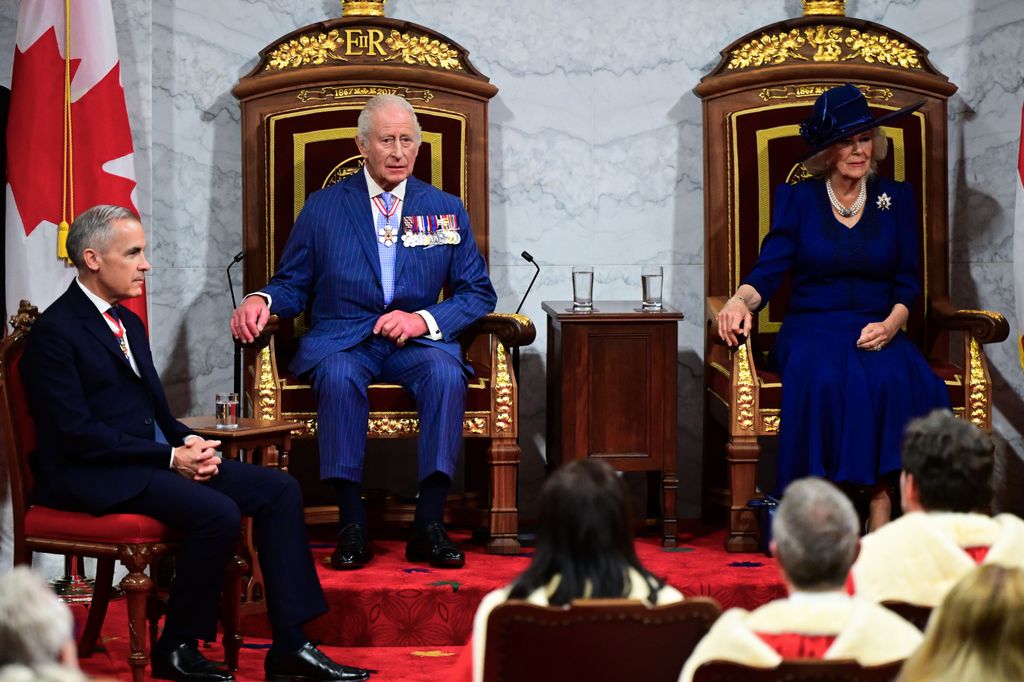 King Charles and Queen Camilla sitting on a pair of thrones