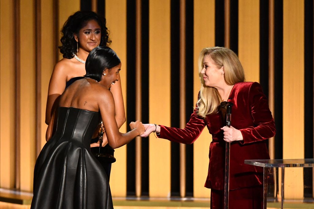 Outstanding Supporting Actress in a Comedy Series Ayo Edebiri, The Bear, shakes hands with US actress Christina Applegate onstage during the 75th Emmy Awards at the Peacock Theatre at L.A. Live in Los Angeles on January 15, 2024