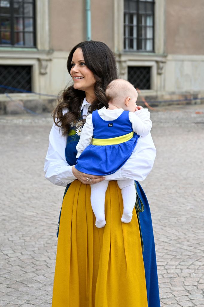 Princess Sofia in traditional dress with baby Ines in her arms