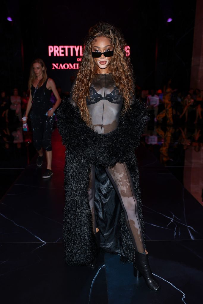 Winnie Harlow in lace bra and sheer catsuit at PrettyLittleThing x Naomi Campbell 