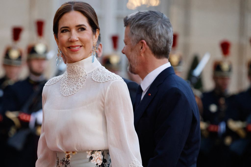 Queen Mary wearing high-neck blouse and gold and blue earrings in France