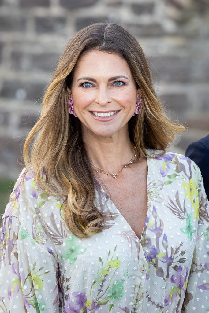 Princess Madeleine smiling in a floral dress
