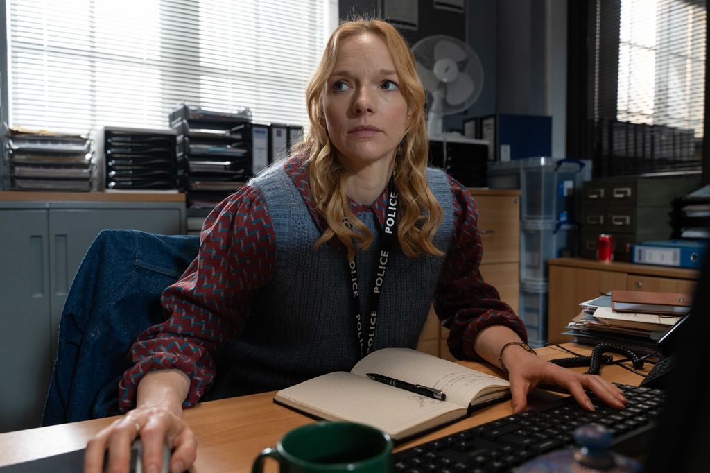 female police officer sitting at desk