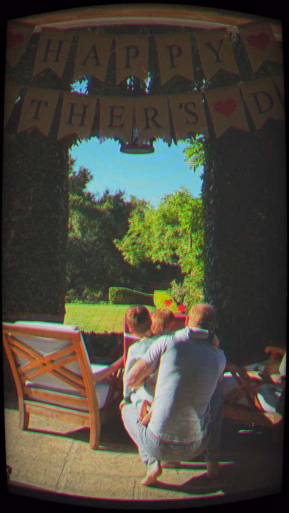 Prince Harry crouching with his two kids overlooking the garden