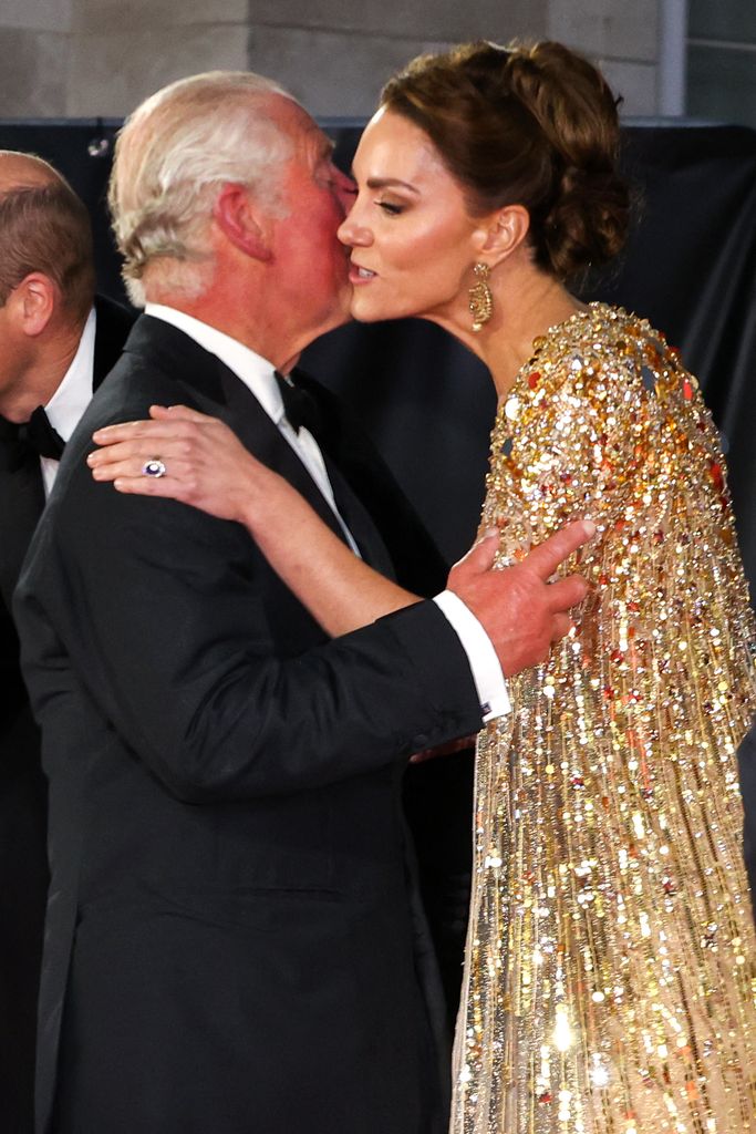 King Charles kisses Britain's Princess Kate as they arrive for the World Premiere of the James Bond 007 film No Time to Die in 2021