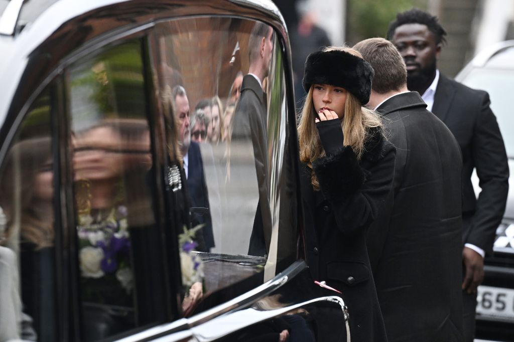 Darcey Draper prepares to carry her father's coffin