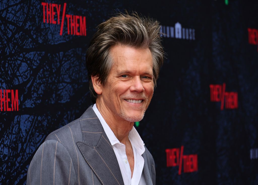 Kevin Bacon hits the red carpet in a grey suit and white shirt