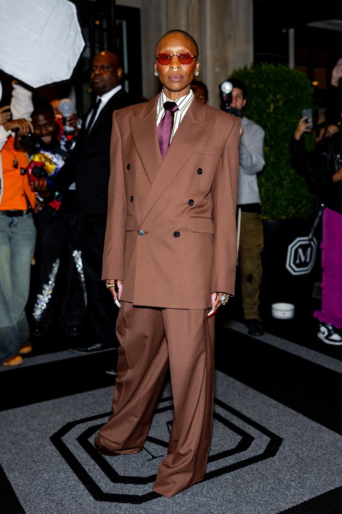 Cynthia Erivo in a brown suit while posing for photos outside hotel on Upper East Side