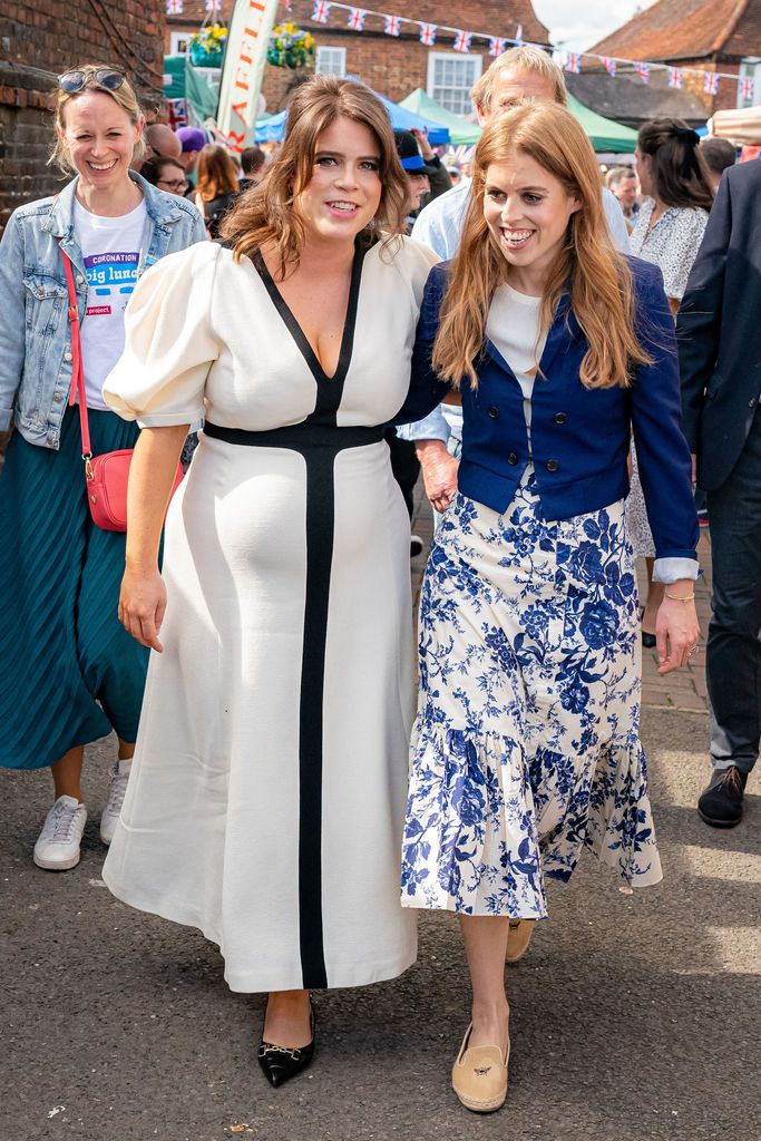 Britain's Princess Beatrice of York (R) and Britain's Princess Eugenie of York (L) attend the Coronation Big Lunch in Chalfont St Giles, north of London on May 7, 2023