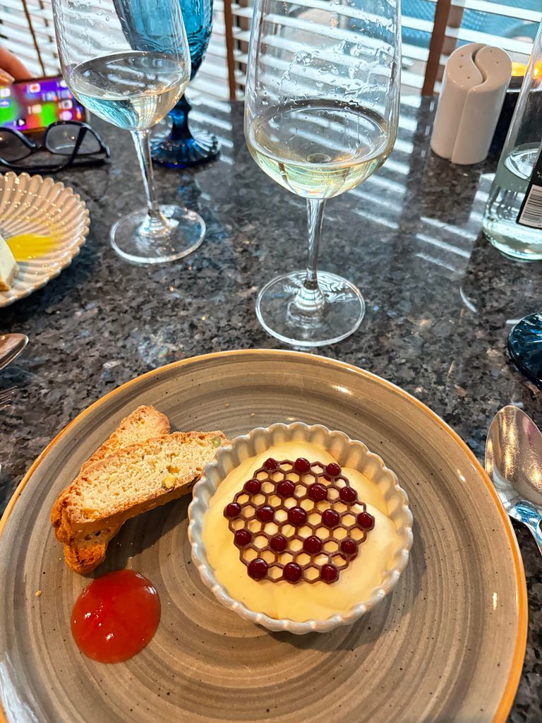 A white chocolate mousse, biscotti and a glass of white wine