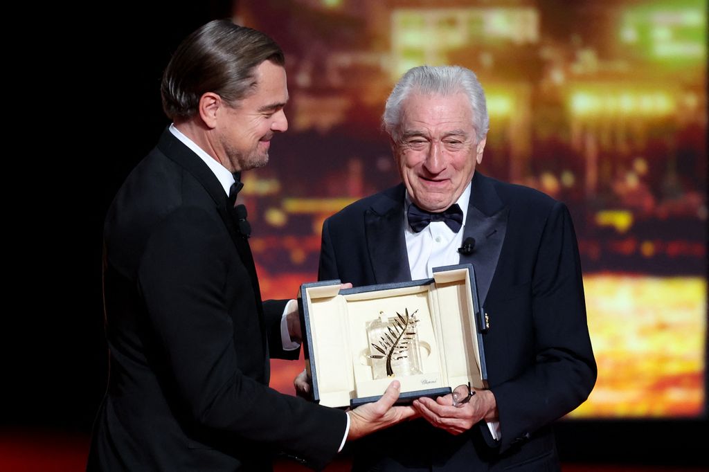 US actor Robert De Niro receives the Honorary Palme d'Or from US actor Leonardo Dicaprio during the Opening Ceremony of the 78th edition of the Cannes Film Festival in Cannes, southern France, on May 13, 2025.