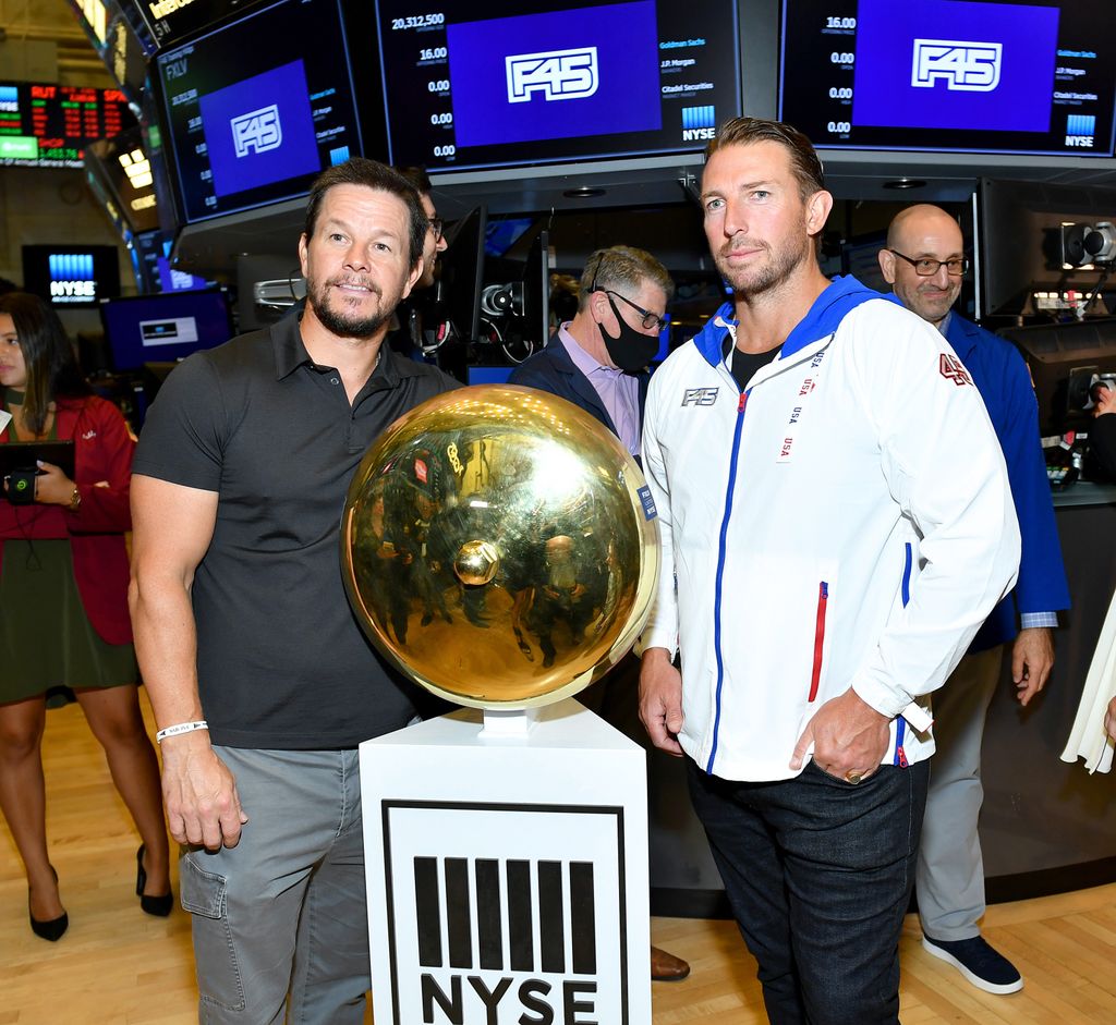 Mark Wahlberg and F45 Founder and CEO Adam Gilchrist pose on the trading floor as F45 Training rings the opening bell at the New York Stock Exchange on July 15, 2021 in New York City