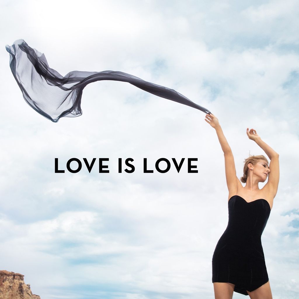 Celine Dion with a billowing silky scarf with the words Love is Love