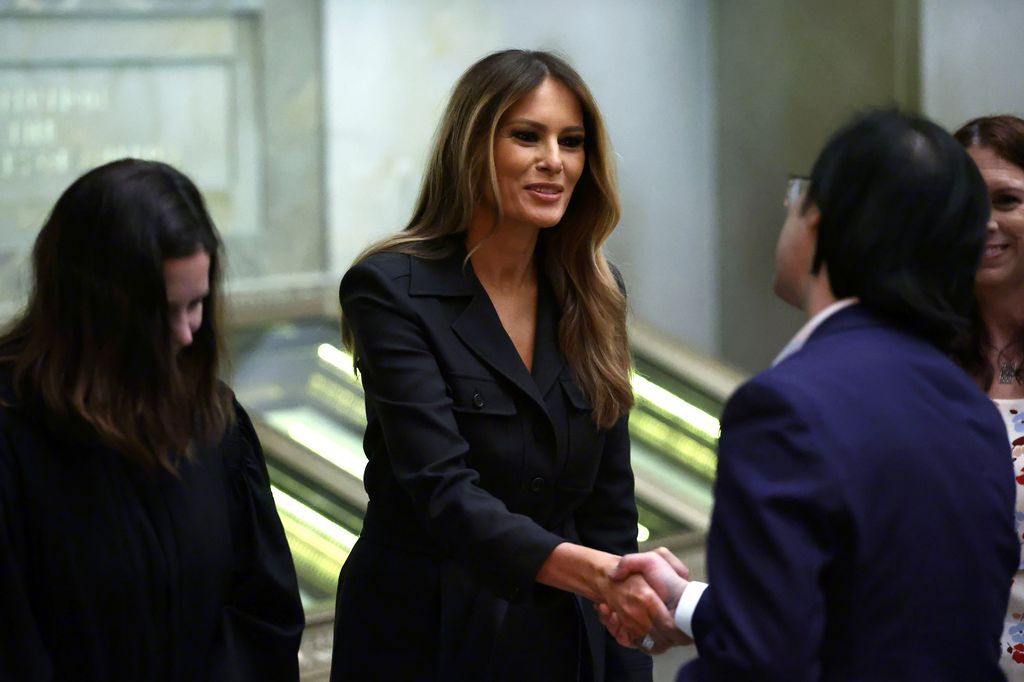 WASHINGTON, DC - DECEMBER 15: Former U.S. first lady Melania Trump (C) shakes hands with new U.S. citizens during a naturalization ceremony at the National Archives on December 15, 2023 in Washington, DC. During the ceremony 25 people from 25 nations were sworn in as new U.S. citizens.  (Photo by Alex Wong/Getty Images)