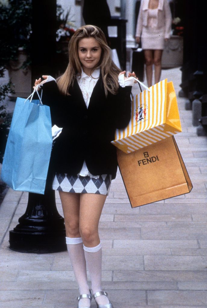 Alicia Silverstone holding shopping bags in a scene from the film 'Clueless', 1995. (Photo by Paramount Pictures/Getty Images)