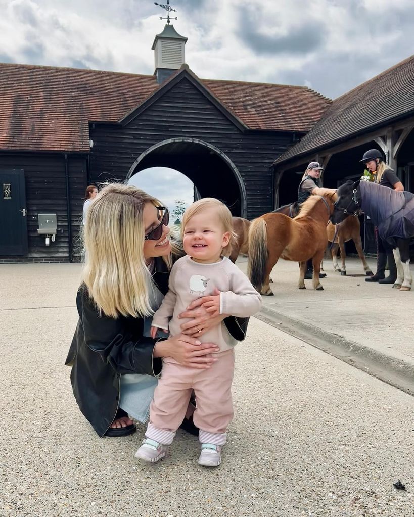 mollie king crouching with annabella at stables