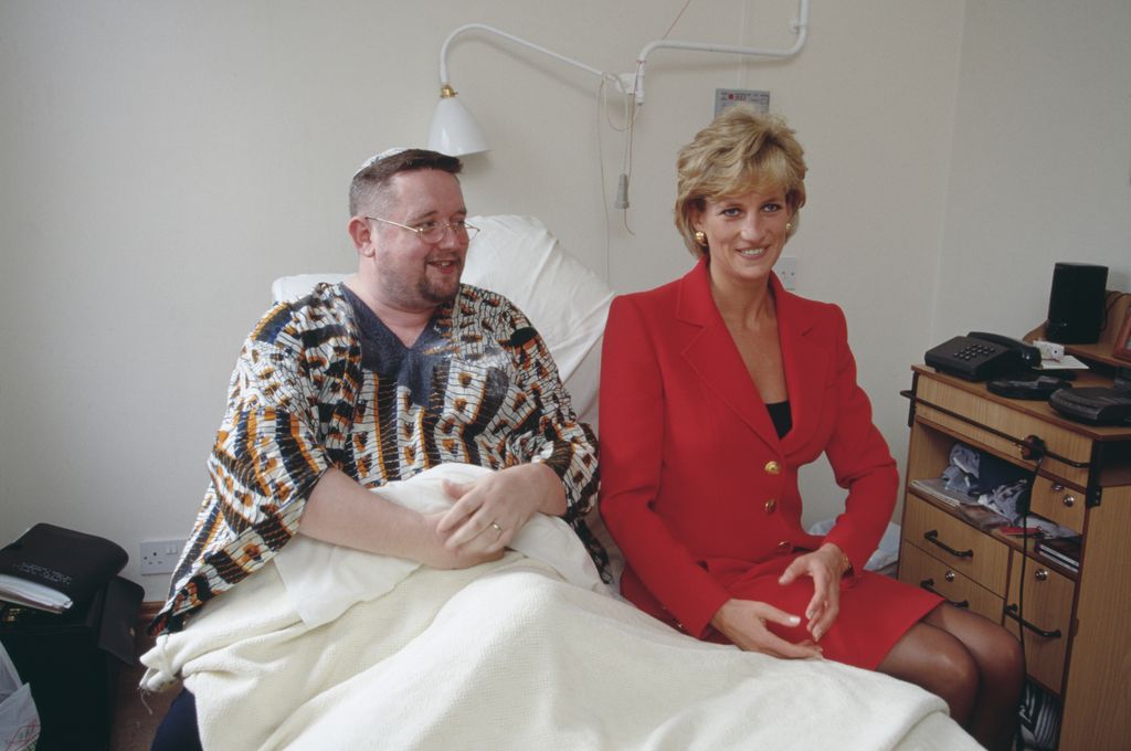 Princess Diana sitting with a patient in a hospital