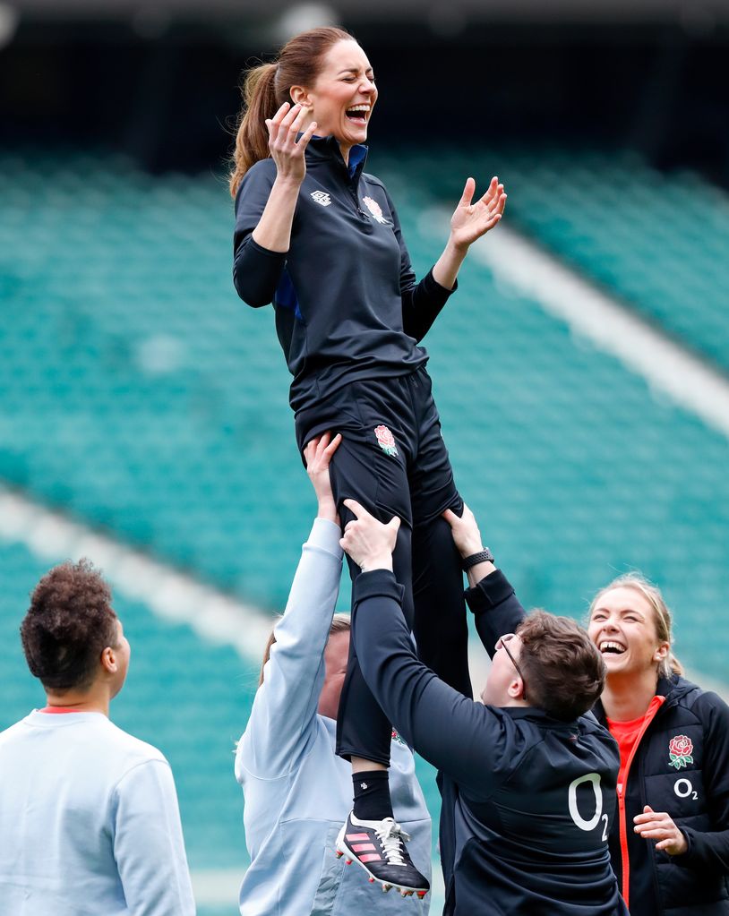 Kate Middleton laughs as she takes part in a lineout drill