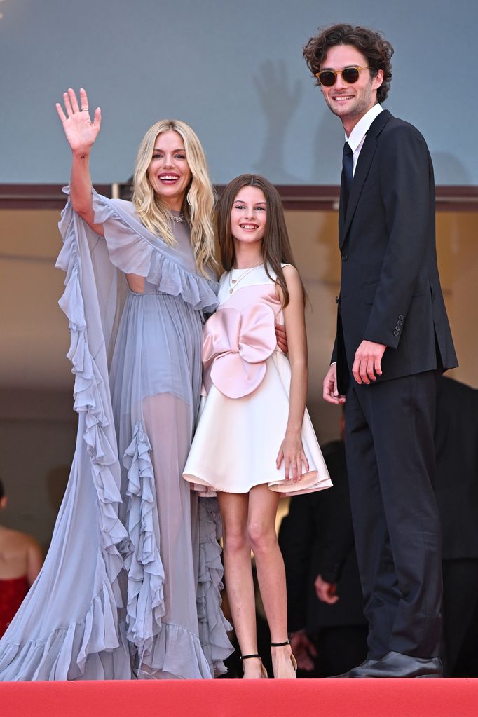 Sienna Miller, Marlowe Ottoline Layng Sturridge and Oli Green attend the "Horizon: An American Saga" Red Carpet at the 77th annual Cannes Film Festival at Palais des Festivals 