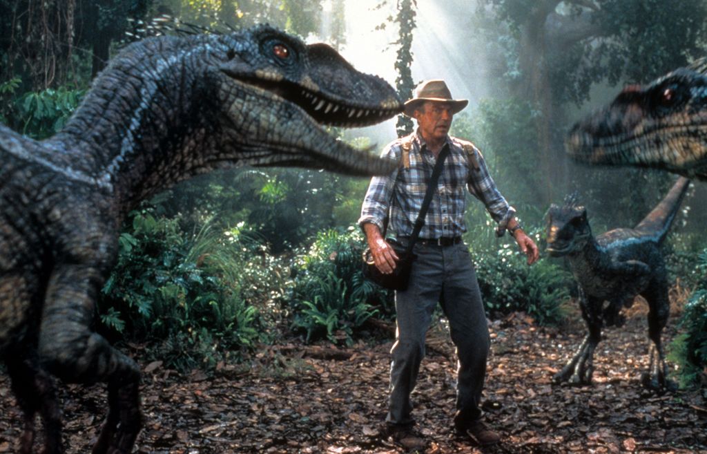 Sam Neill is confronted by three dinosaurs in a scene from the film 'Jurassic Park III', 2001