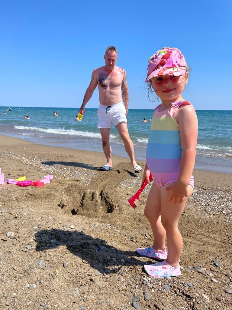 James Jordan builds sandcastles with Ella