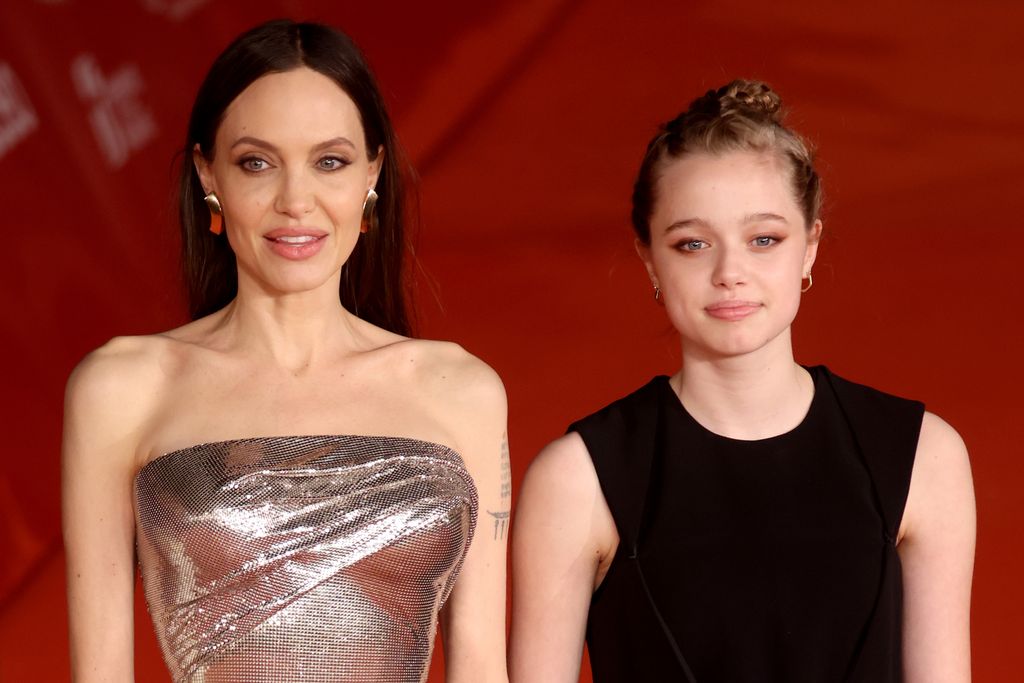 Shiloh Jolie Pitt and Angelina Jolie posing on the red carpet