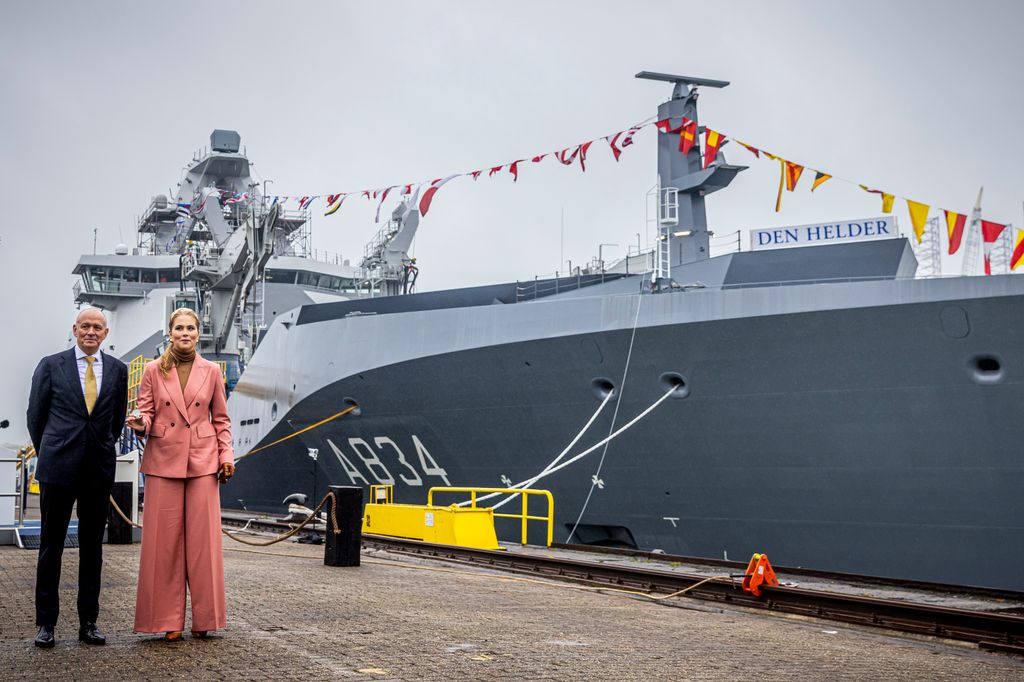 Princess Catharina-Amalia and a man standing outside a battleship