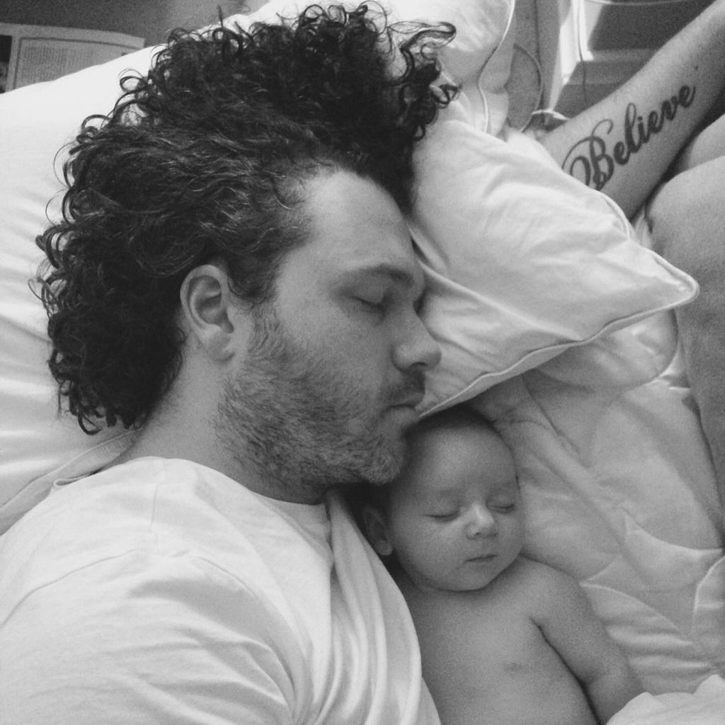 Jack McManus asleep with his baby son