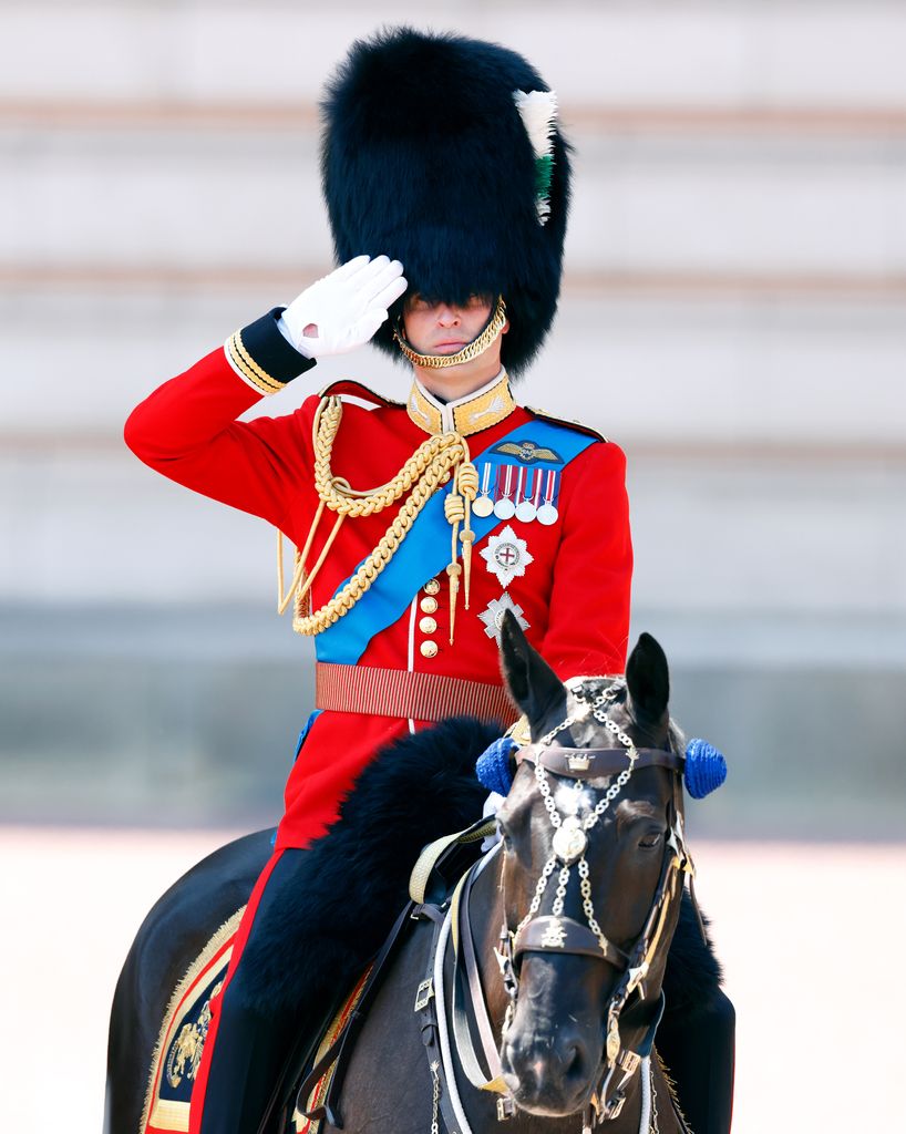 Prince William (in his role as Colonel of the Welsh Guards) takes the salute outside Buckingham Palace 