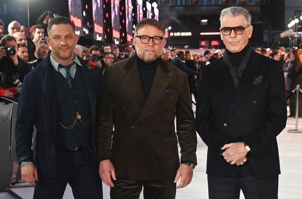 Tom Hardy standing with Guy Ritchie and Pierce Brosnan