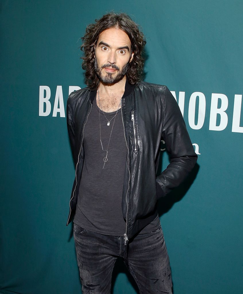 Russell Brand in leather jacket and shirt