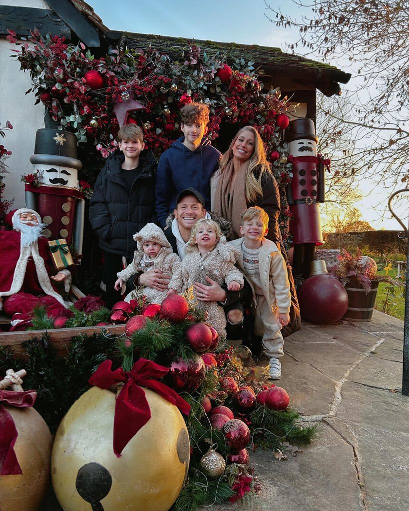 Stacey Solomon stands with Joe Swash and their five children outside a festive foor
