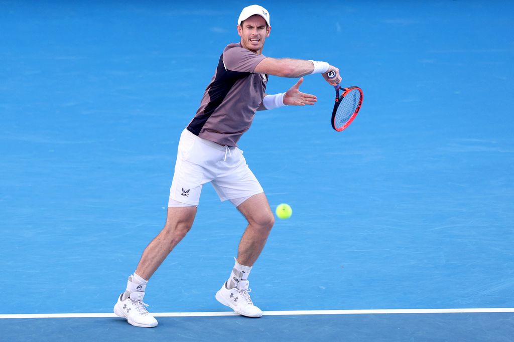 Andy Murray hits tennis ball
