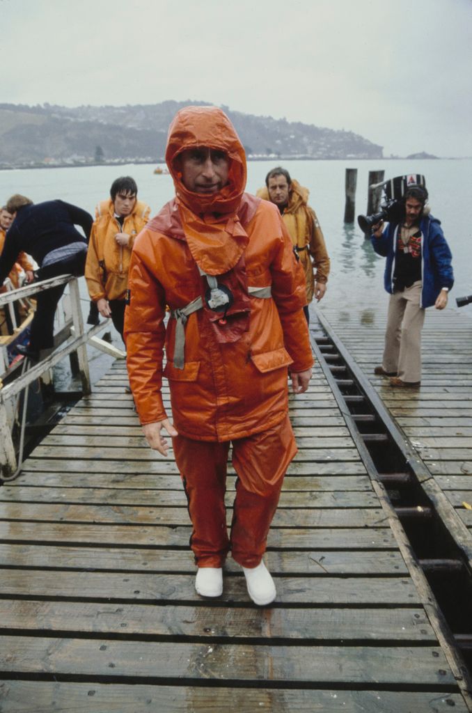 King Charles in orange wetsuit braving rain in Christchurch New Zealand 